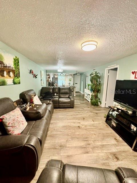 A kitchen features white cabinets, stainless steel appliances, and a large marble-patterned island countertop — 4247 SHELDON PLACE UNIT 1, NEW PORT RICHEY, FL