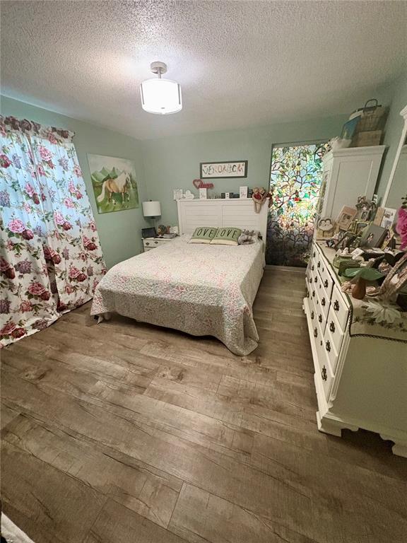 A kitchen features white cabinets, stainless steel appliances, and a stone countertop with a sink — 4247 SHELDON PLACE UNIT 1, NEW PORT RICHEY, FL