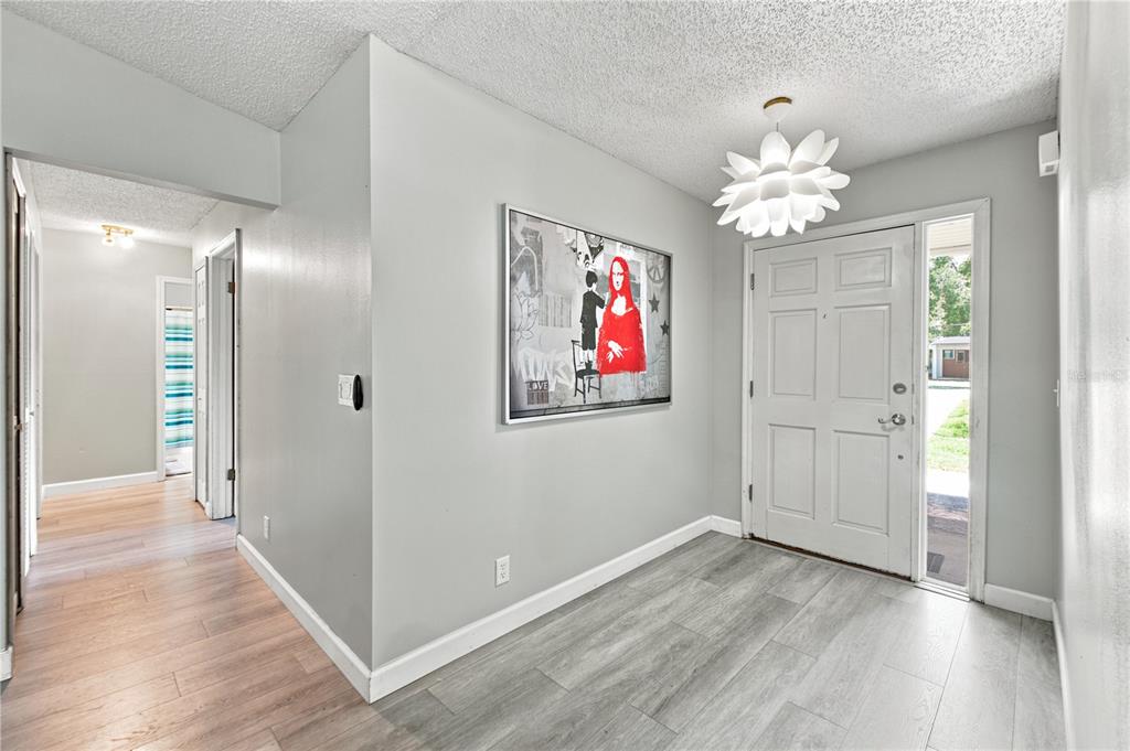 An aerial view shows a single-story house with a large yard and surrounding trees — 3944 NE 7TH STREET, OCALA, FL