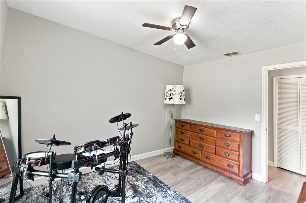 A living room features a large sectional sofa, a fireplace, and a ceiling fan — 3944 NE 7TH STREET, OCALA, FL