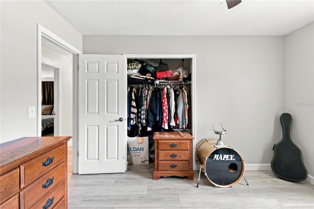 An entryway features gray wood-look flooring, a white front door, and a modern floral chandelier — 3944 NE 7TH STREET, OCALA, FL