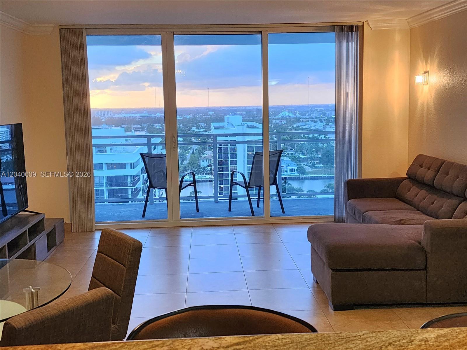A living room features tile floors, a sectional sofa, and a balcony with a city view — 2030 S Ocean Dr # 1901, Hallandale Beach FL 33009, HALLANDALE BEACH, FL