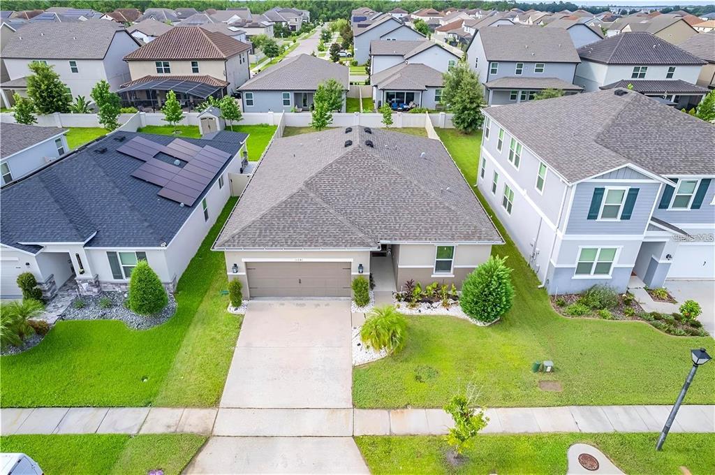 An aerial view of a single-story suburban house with a gray roof and driveway — 13941 RUSHING CREEK RUN, ORLANDO, FL