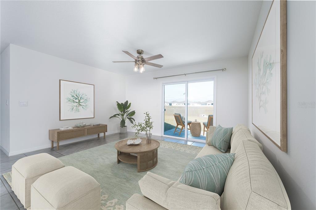 A living room features a beige sofa, a round wooden coffee table, and sliding glass doors — 1265 NW 248TH DRIVE, NEWBERRY, FL
