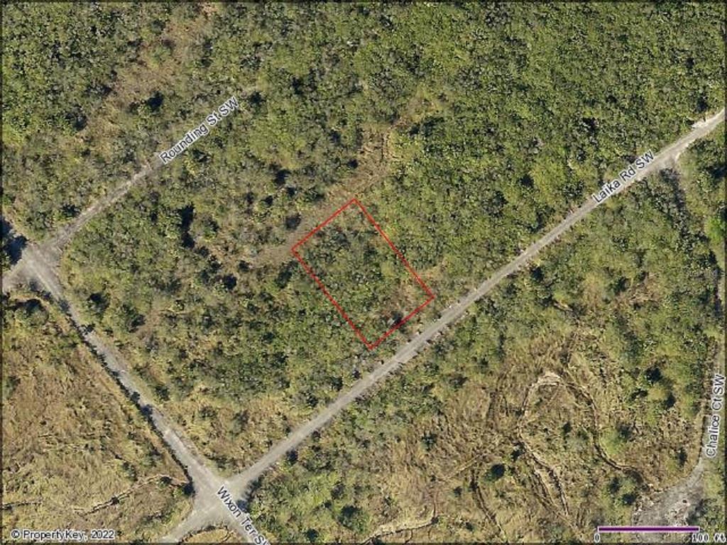 This aerial map shows a rectangular plot of land outlined in red near unpaved roads — 981 LAIKA ROAD SW, PALM BAY, FL