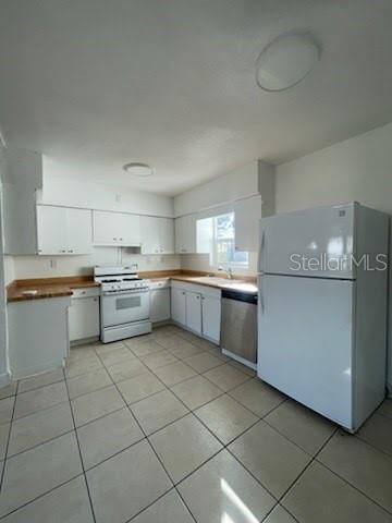 A kitchen with white cabinets, light tile floors, and white appliances — 331 51ST STREET COURT W, PALMETTO, FL