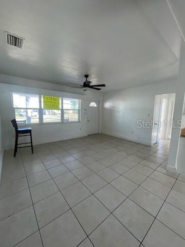 A bright, empty room features white walls, a ceiling fan, and light-colored tile flooring — 331 51ST STREET COURT W, PALMETTO, FL