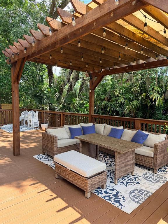 A living room features a brick fireplace, vaulted wood-paneled ceiling, sectional sofa, and sliding doors — 725 LAKE AVENUE, ALTAMONTE SPRINGS, FL