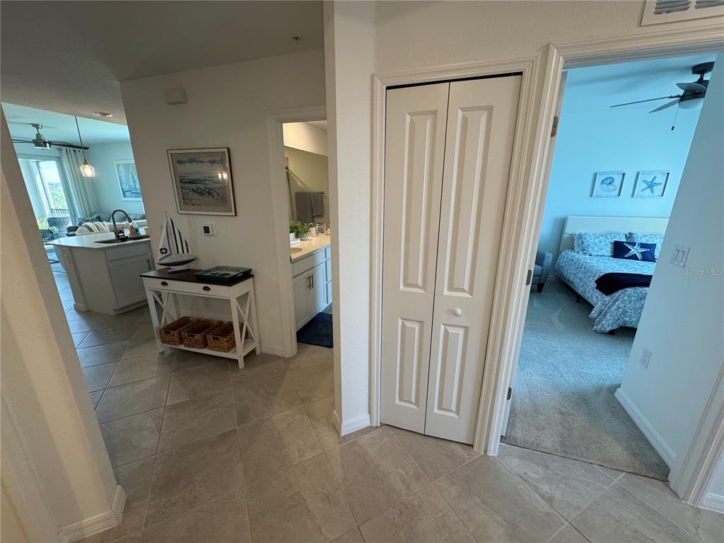 A tiled hallway leads to a kitchen, a bathroom, a closet, and a bedroom — 12240 WELLEN GOLF STREET UNIT 208, VENICE, FL