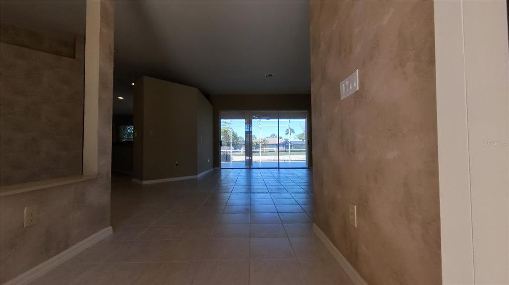 A house with a screened-in patio and a large blooming crape myrtle tree — 11837 GRAND ISLES LANE, FORT MYERS, FL