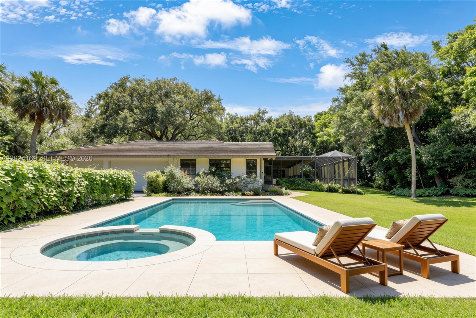 A backyard features a rectangular swimming pool, a circular spa, and two lounge chairs — 9979 Fairchild Way, Coral Gables FL 33156, CORAL GABLES, FL