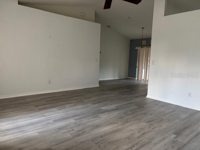 An open living area features light gray wood-look flooring and vaulted ceilings — 1707 W BEACH PLUM DRIVE, CITRUS SPRINGS, FL