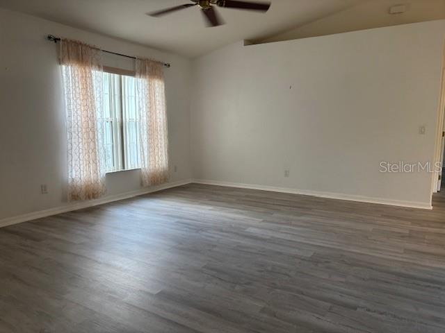 An empty room with light wood-look flooring, white walls, and a window with patterned curtains — 1707 W BEACH PLUM DRIVE, CITRUS SPRINGS, FL