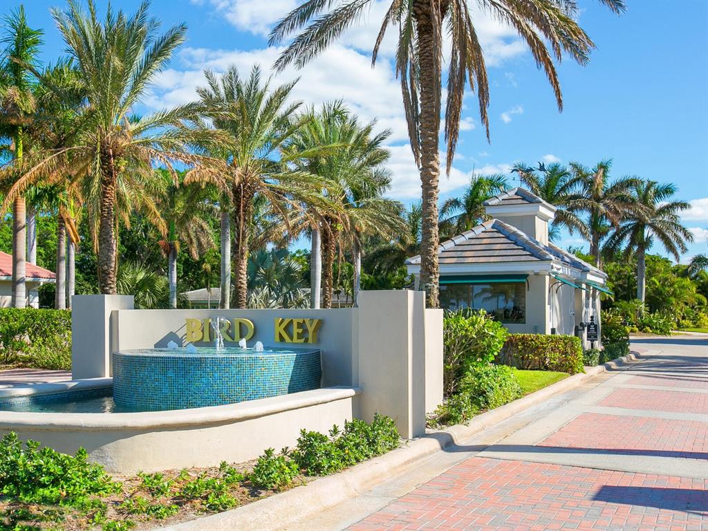 A blue tiled fountain sits in front of a Bird Key entrance sign and guardhouse — 332 BOB WHITE WAY, SARASOTA, FL