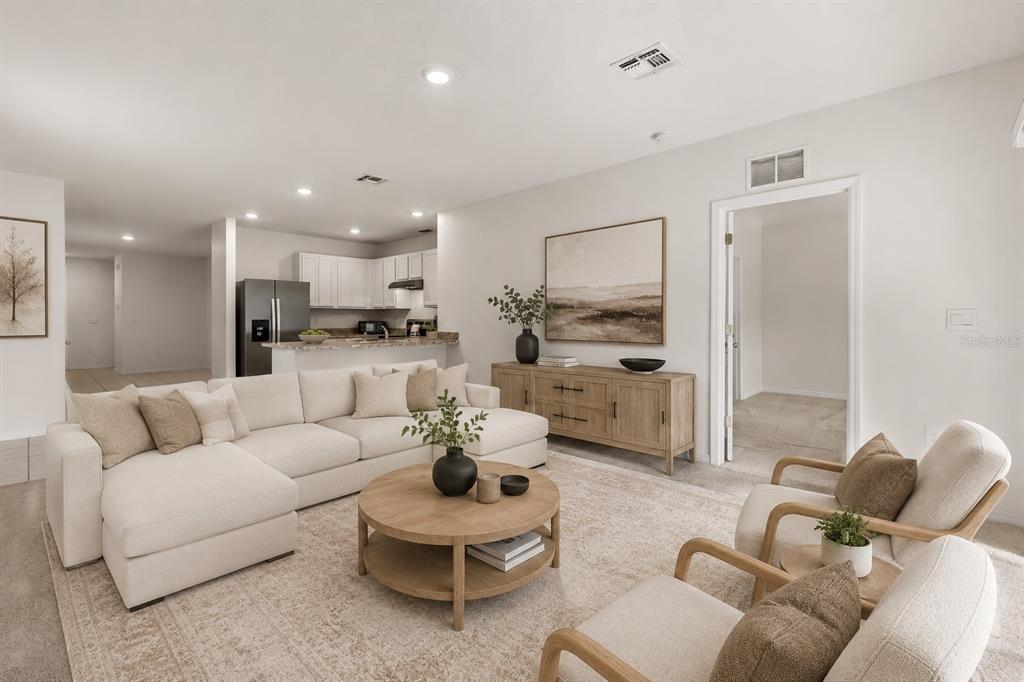A living room features a sectional sofa, two armchairs, a coffee table, and an open kitchen — 289 GINA LANE, DAVENPORT, FL