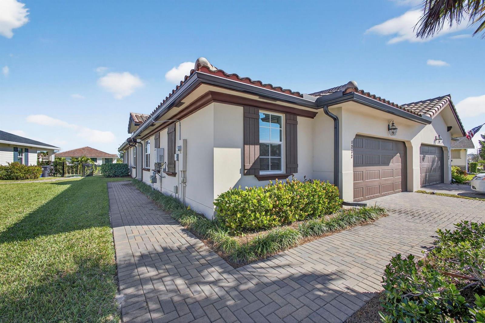 A single-story house with a paved driveway, a walkway, and a two-car garage — 1232 Haywagon Trail # 0, Loxahatchee FL 33470, LOXAHATCHEE, FL