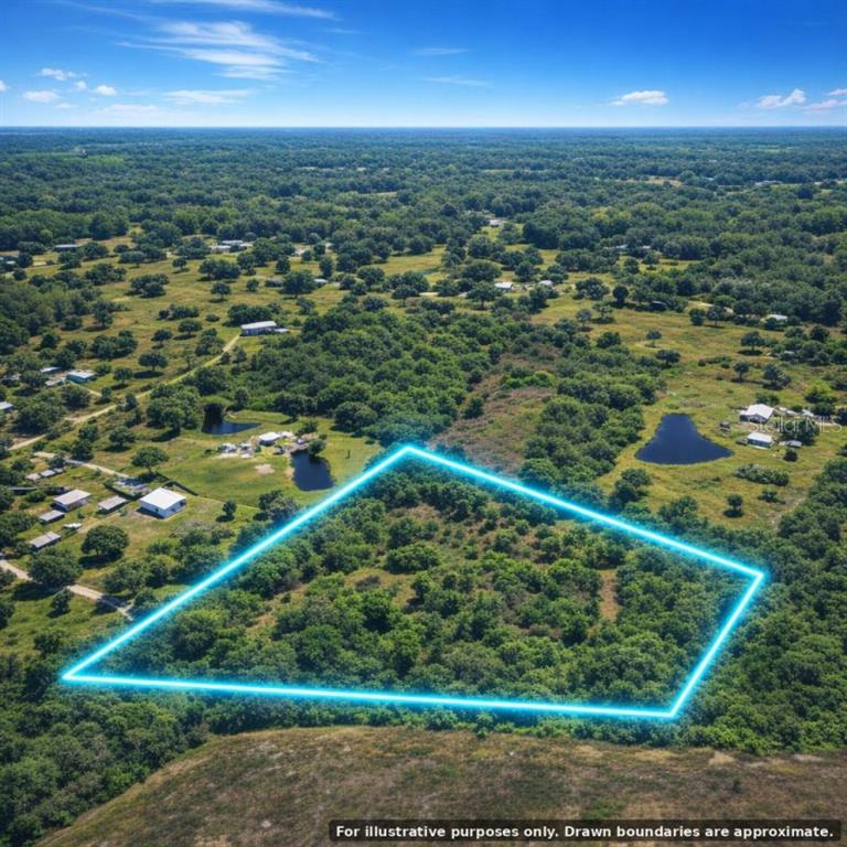 An aerial view shows a wooded plot of land outlined in blue against a rural landscape — 14115 CYPRESS LANE, WIMAUMA, FL