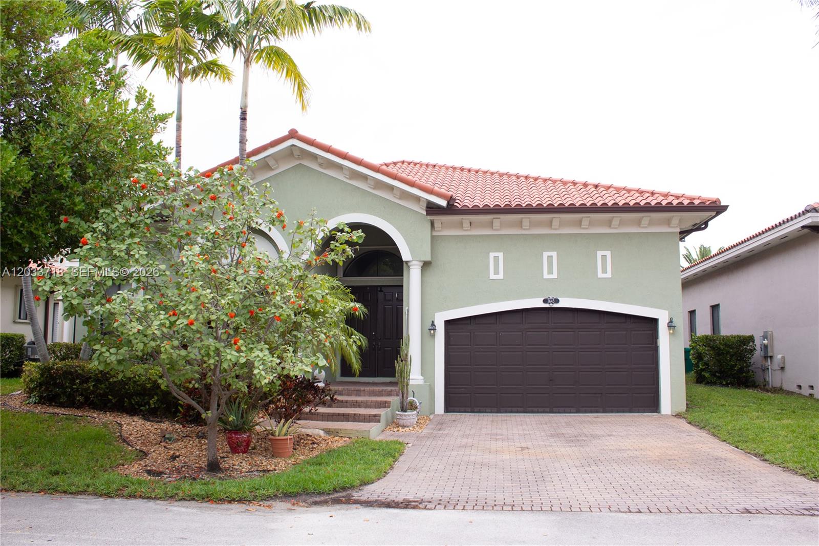 A single-story house with a green stucco exterior, a brown garage door, and a tiled roof — 7645 SW 193rd Ln, Cutler Bay FL 33157, CUTLER BAY, FL
