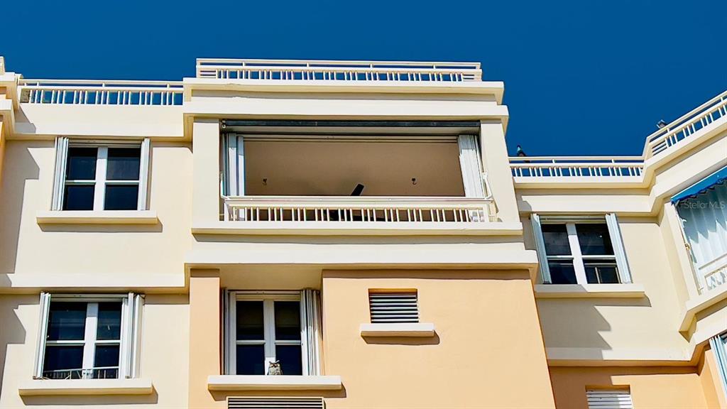 The exterior of a multi-story building features a balcony, windows, and light-colored stucco walls — 3 CARR 115 PLAYA ALMIRANTE UNIT PH 605B, ANASCO, PR