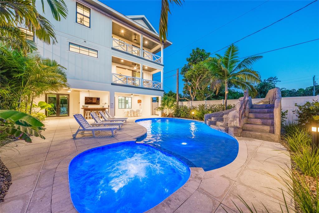A three-story house with a pool, hot tub, and rock slide in the backyard — 6910 MIDNIGHT PASS ROAD UNIT A, SARASOTA, FL