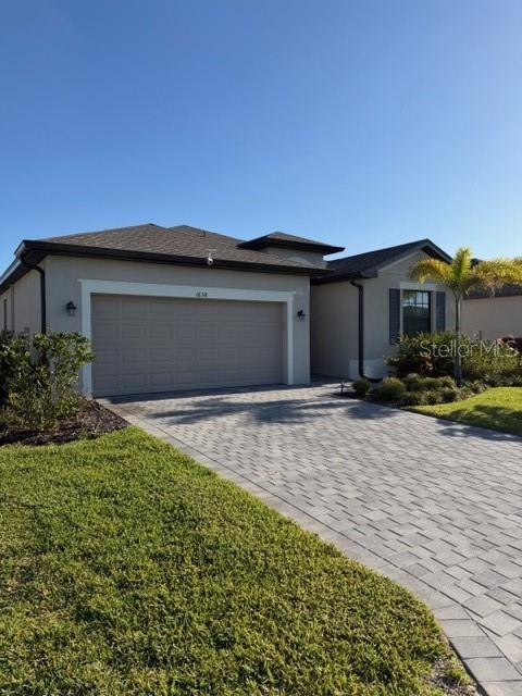 A single-story house with a beige exterior, a two-car garage, and a paved driveway — 1638 SADDLEWOOD CIRCLE, PORT CHARLOTTE, FL