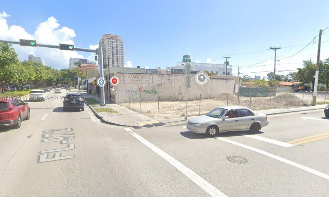 A vacant lot with a graffiti-covered wall sits at a street intersection — 3398 Coral Way, Miami FL 33145, MIAMI, FL