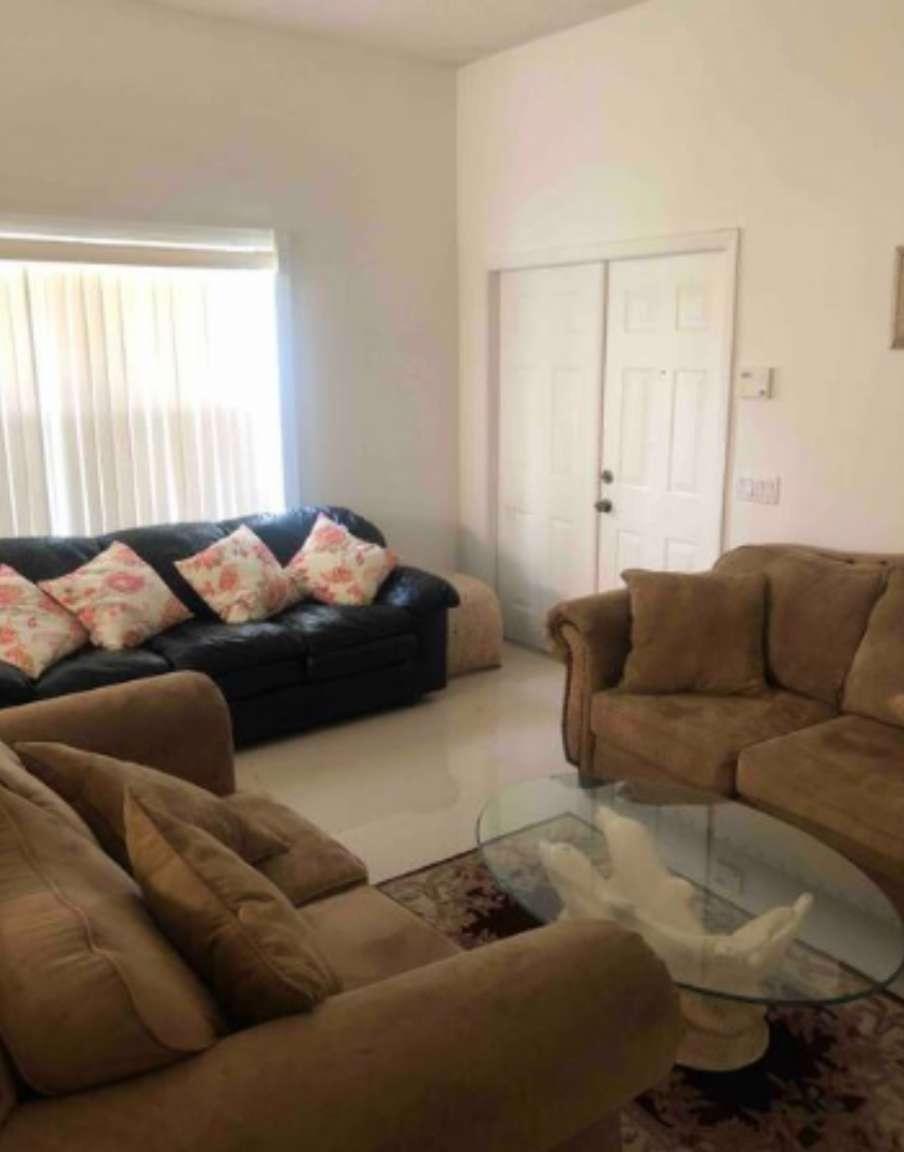 A living room features a black leather sofa, two brown fabric sofas, and a glass table — 862 Vista Meadows Drive, Weston FL 33327, WESTON, FL
