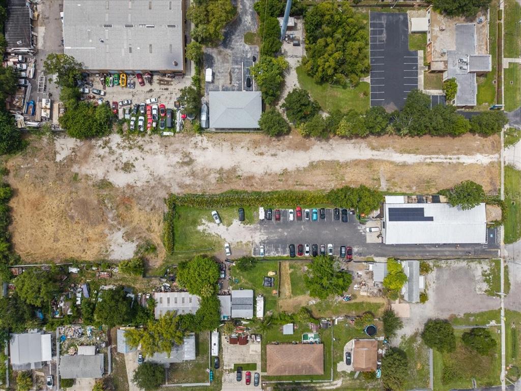 Aerial view of a commercial property with a large vacant lot and parking areas — 4685 PARK STREET N, ST PETERSBURG, FL