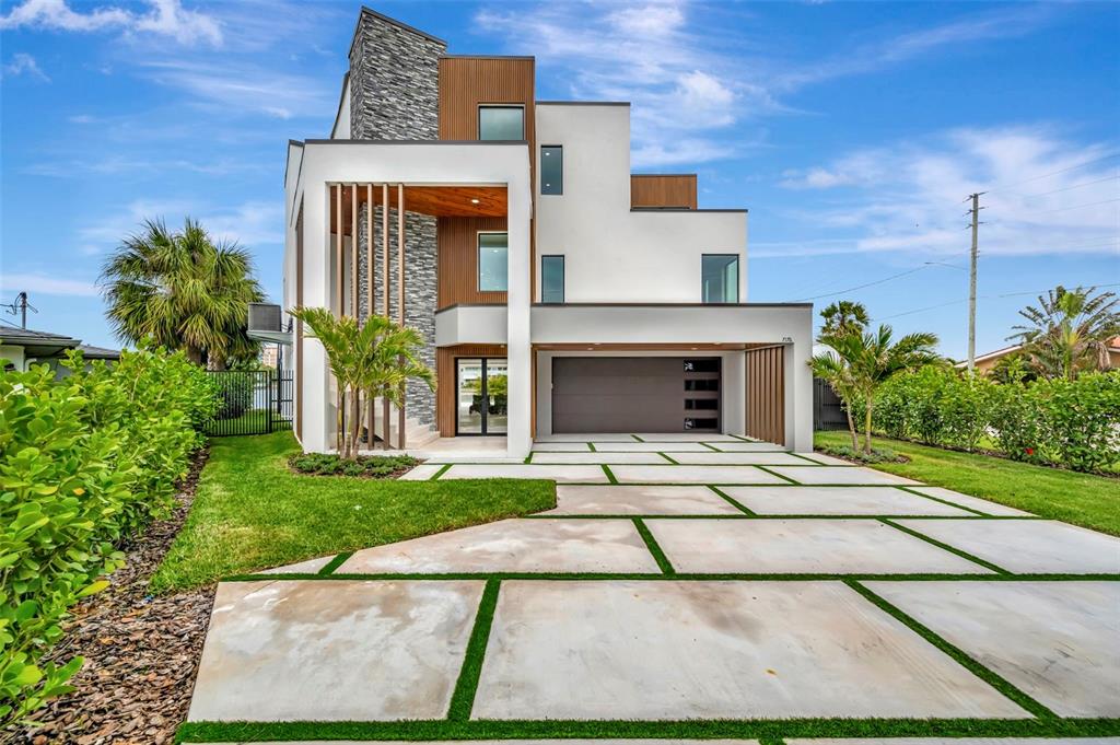 A modern kitchen features gray and white cabinetry, a large island, and a water view — 7176 S SHORE DRIVE S, ST PETERSBURG, FL