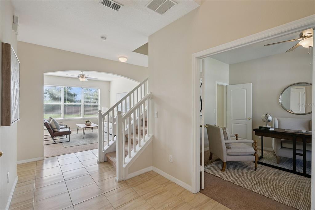 A tiled entryway leads to a carpeted staircase, a living area, and a home office — 240 MAGNOLIA PARK TRAIL, SANFORD, FL