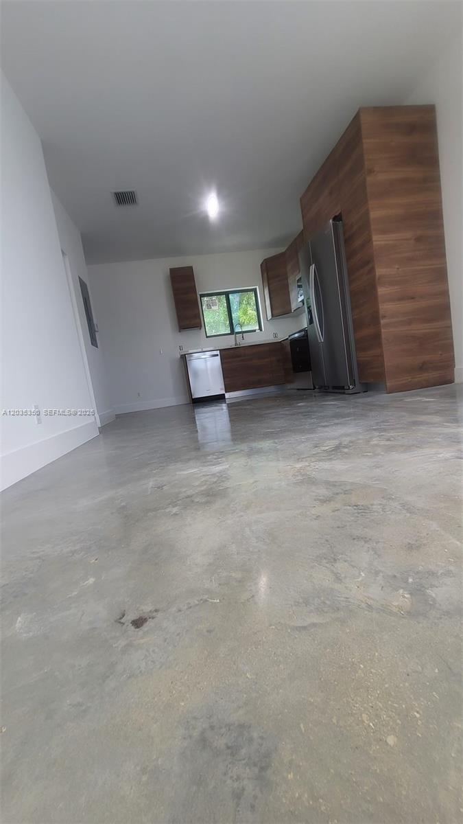 A kitchen features wood-grain cabinetry, stainless steel appliances, and a polished concrete floor — 2146 NW 69th Ter # B, Miami FL 33147, MIAMI, FL