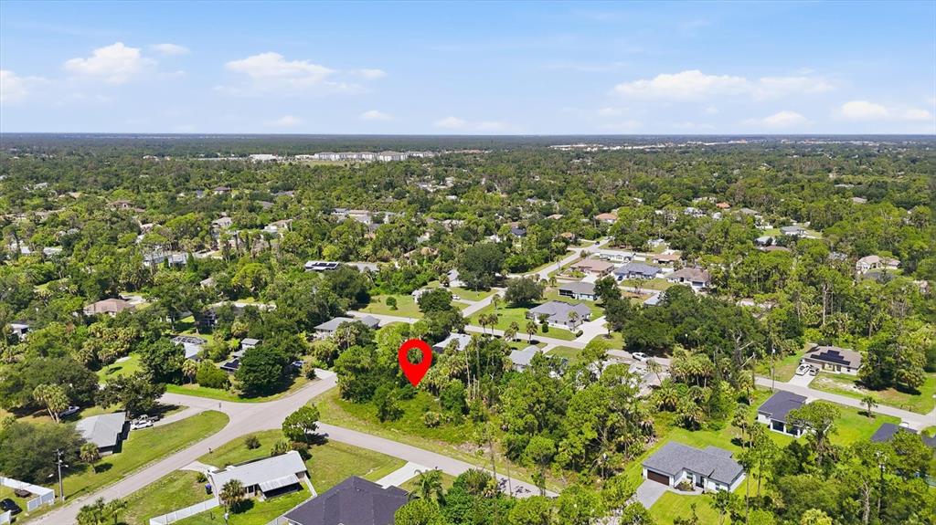 An aerial view shows a vacant, tree-covered residential lot marked with a red location pin — EASTER TERRACE, NORTH PORT, FL