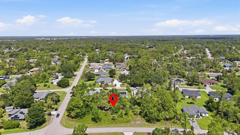 An aerial view shows a vacant, wooded residential lot marked with a red pin — EASTER TERRACE, NORTH PORT, FL
