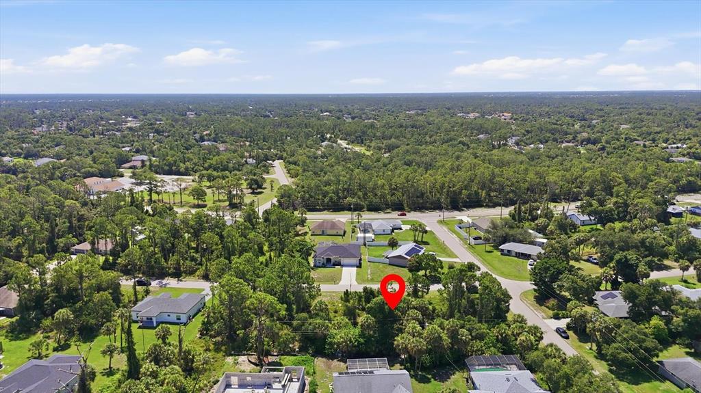 An aerial view shows a wooded residential lot marked with a red pin — EASTER TERRACE, NORTH PORT, FL