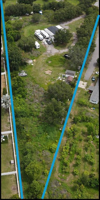 An aerial view shows a large, narrow, partially wooded lot with a house and RVs — 4122 HIGH PLAINS LANE, KISSIMMEE, FL