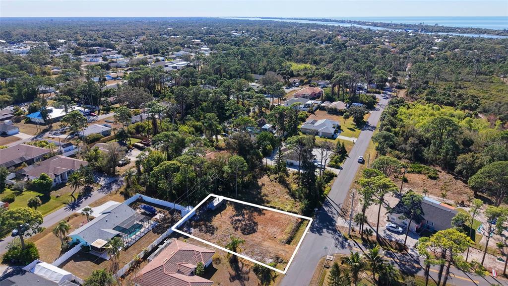 An aerial view shows a vacant rectangular lot bordered by a road and residential houses — 5993 OSPREY ROAD, VENICE, FL
