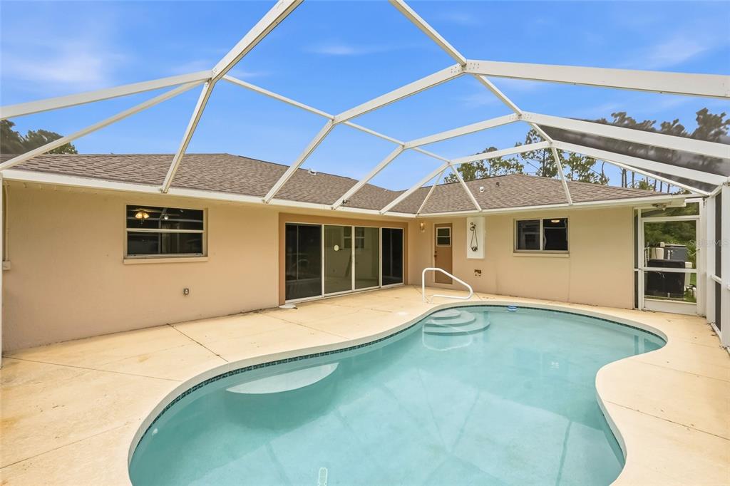 An entryway with wood-look flooring, a white front door, and a bay window — 2209 TROPICAIRE BOULEVARD, NORTH PORT, FL