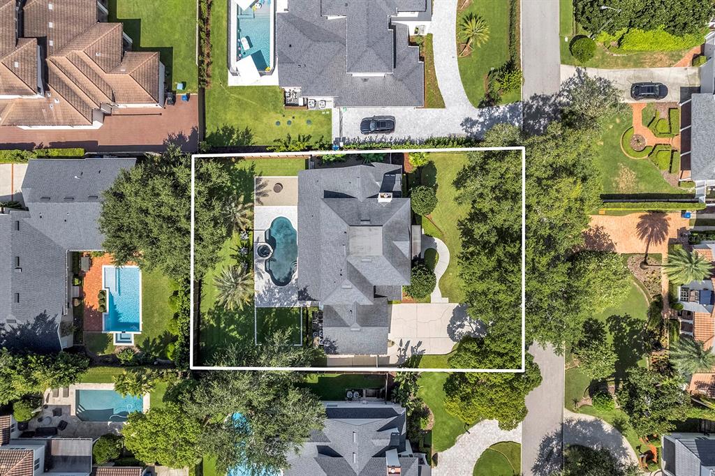An aerial view shows a residential property with a swimming pool and surrounding landscaping — 948 POINCIANA LANE, WINTER PARK, FL