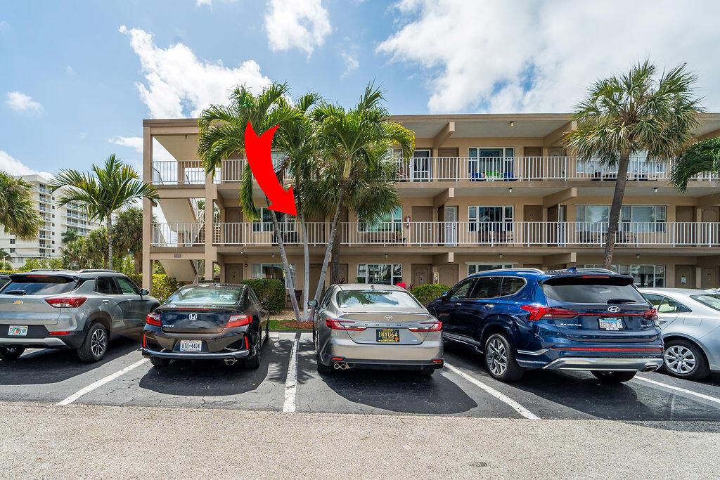 Exterior view of a multi-story apartment building with a parking lot and palm trees — 3200 NE 7th Court Unit 201a, Pompano Beach FL 33062, POMPANO BEACH, FL