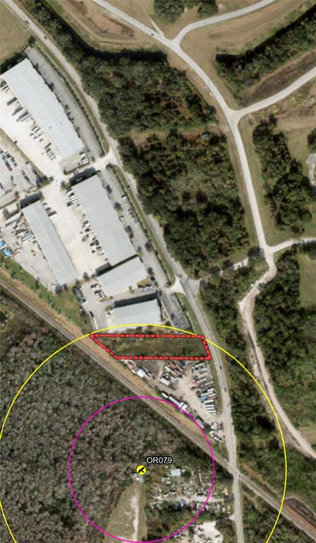 This aerial map shows a rectangular plot of land outlined in red near industrial buildings — BOGGY CREEK ROAD, ORLANDO, FL