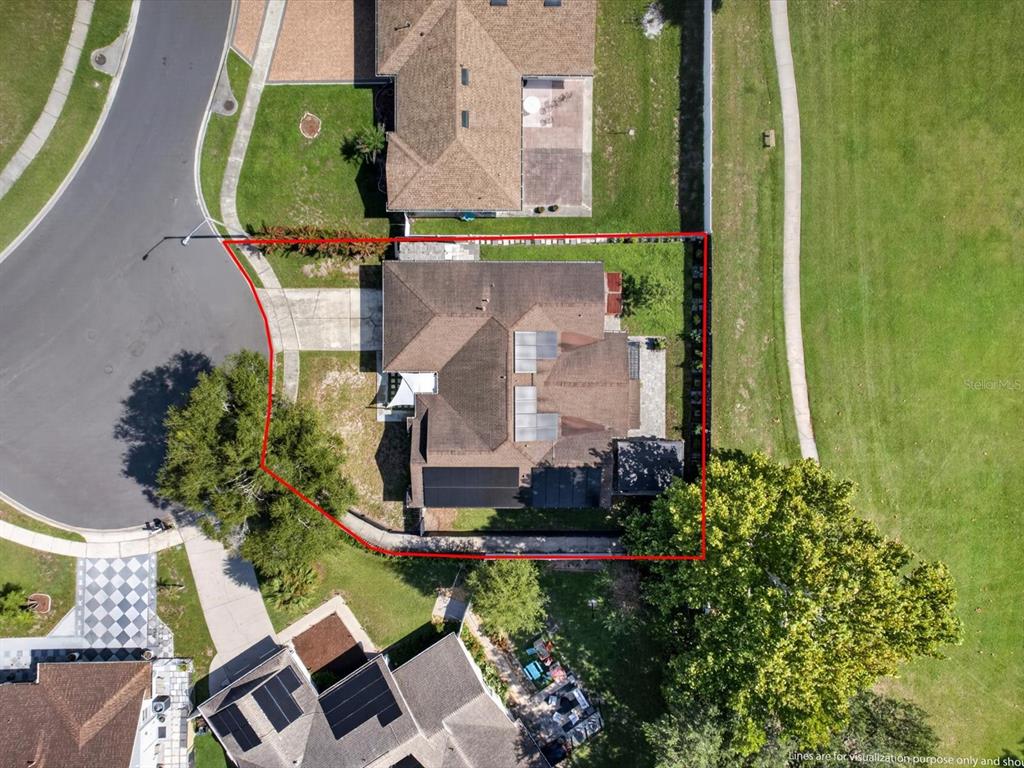 An aerial view shows a residential house with a red outline marking its property boundaries — 2704 MUSCATELLO STREET, ORLANDO, FL