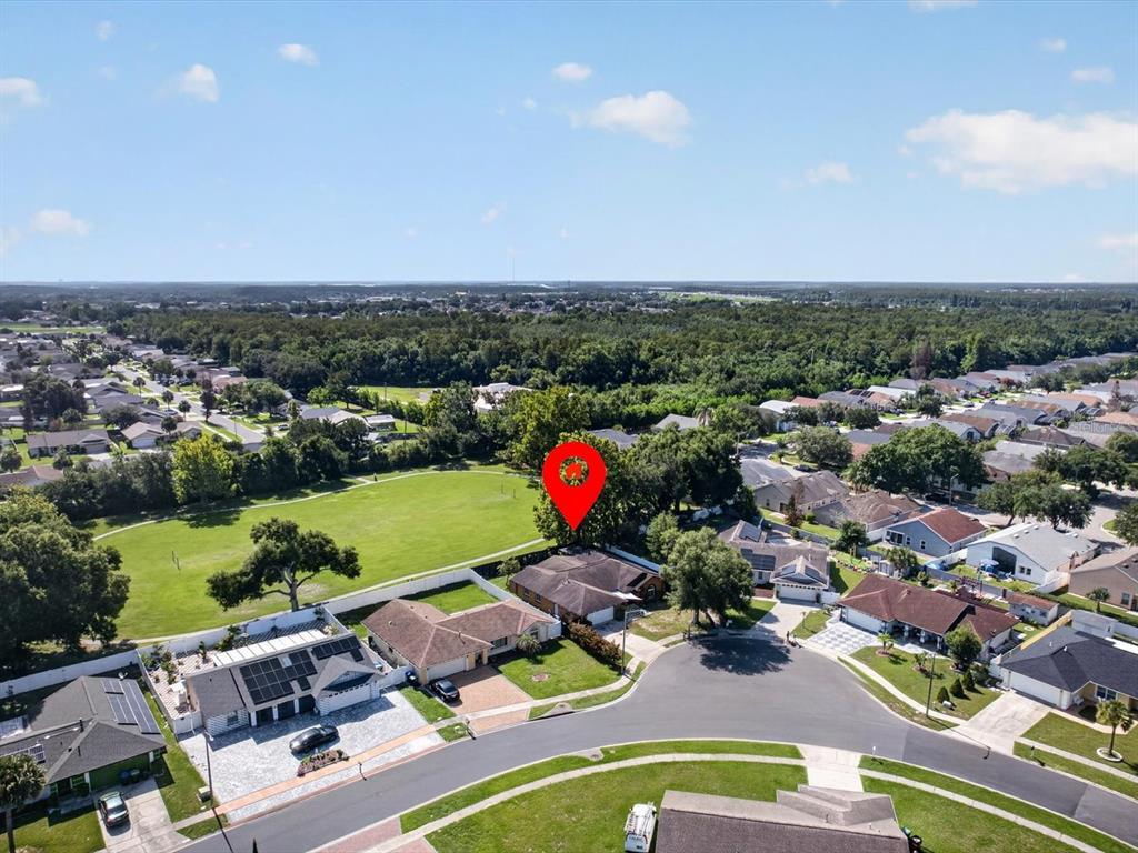 An aerial view shows a residential neighborhood with a house marked by a red pin — 2704 MUSCATELLO STREET, ORLANDO, FL