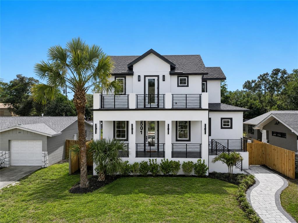 A two-story white house with black trim, a front porch, and a second-floor balcony — 2501 QUINCY STREET S, ST PETERSBURG, FL