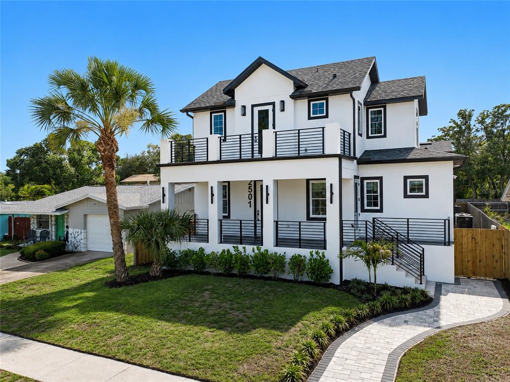 A two-story white house with black trim, a front porch, and a second-floor balcony — 2501 QUINCY STREET S, ST PETERSBURG, FL