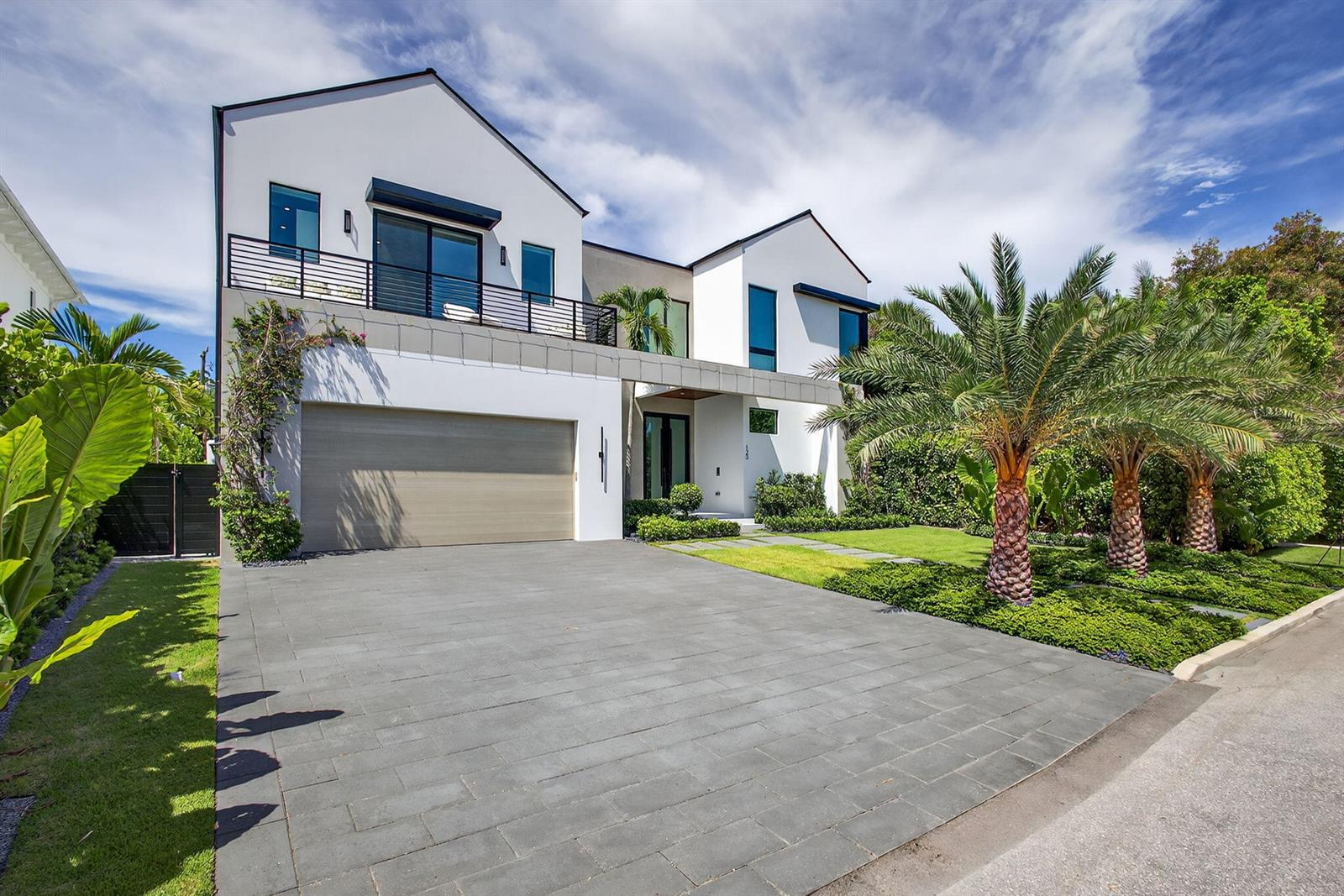 A modern two-story house with a white exterior, a gray garage door, and palm trees — 123 Murray Road, West Palm Beach FL 33405, WEST PALM BEACH, FL