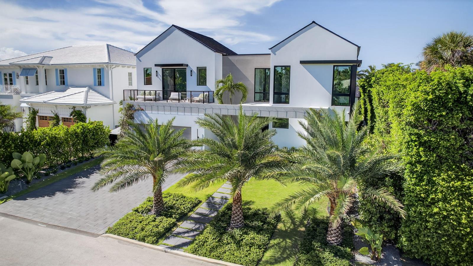 A modern white two-story house with a balcony, palm trees, and a paved driveway — 123 Murray Road, West Palm Beach FL 33405, WEST PALM BEACH, FL