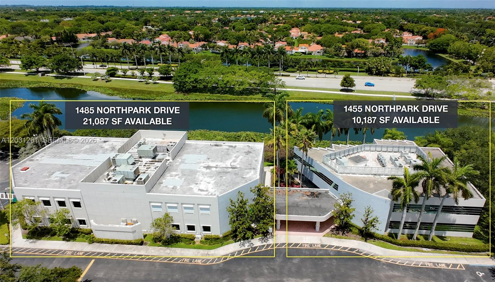 An aerial view shows two adjacent commercial office buildings situated next to a lake — 1455-1485 N Park Dr, Weston FL 33326, WESTON, FL