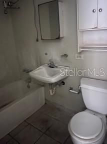 A small bathroom features a white sink, a toilet, a bathtub, and a wall-mounted cabinet — B 1304 COND. TORRES DE CERVANTES UNIT 1, SAN JUAN, PR