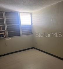 An empty room features light-colored walls, tiled flooring, and windows with horizontal blinds — B 1304 COND. TORRES DE CERVANTES UNIT 1, SAN JUAN, PR