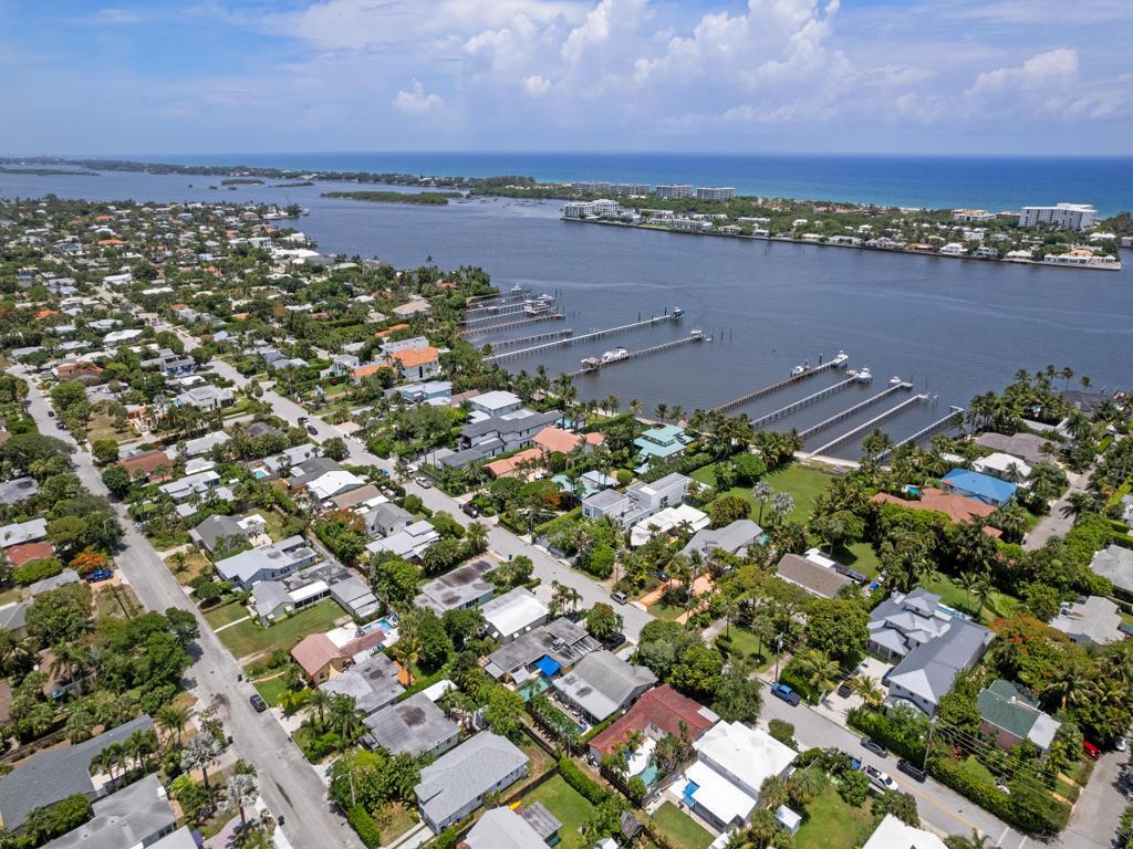 An aerial view shows a residential neighborhood with docks extending into a large bay — 1615 N Lakeside Drive, FL 33460, FL